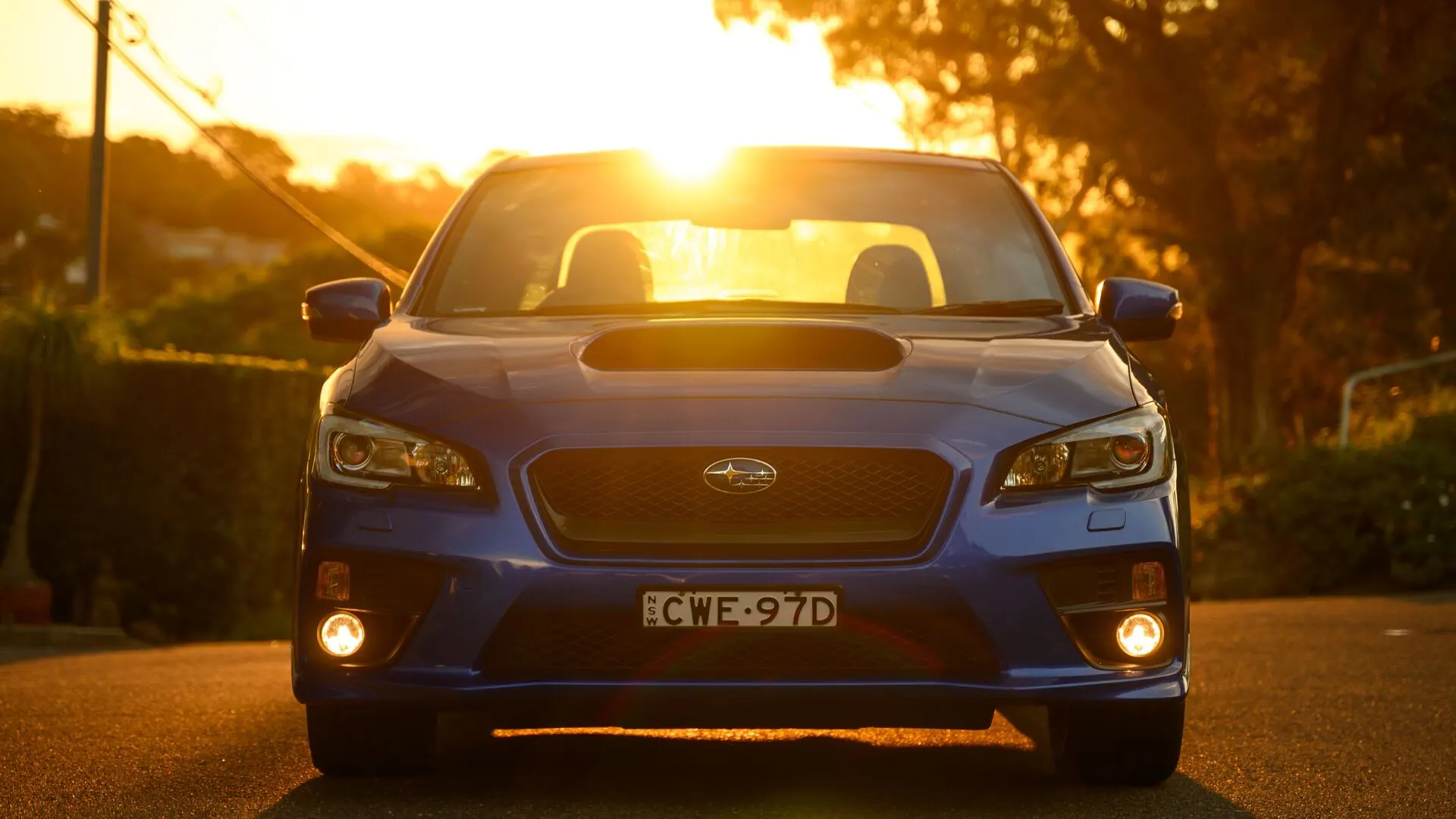 A car at sunset on a suburban street